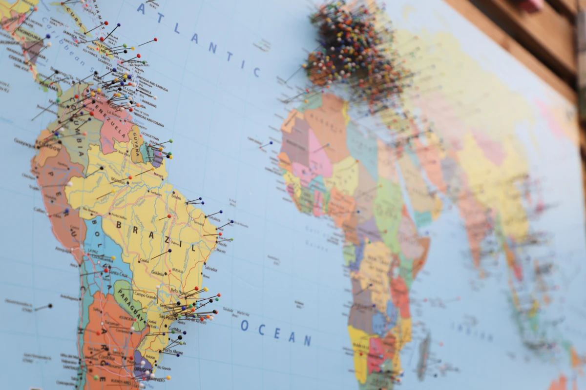 A world map with pins across the Americas