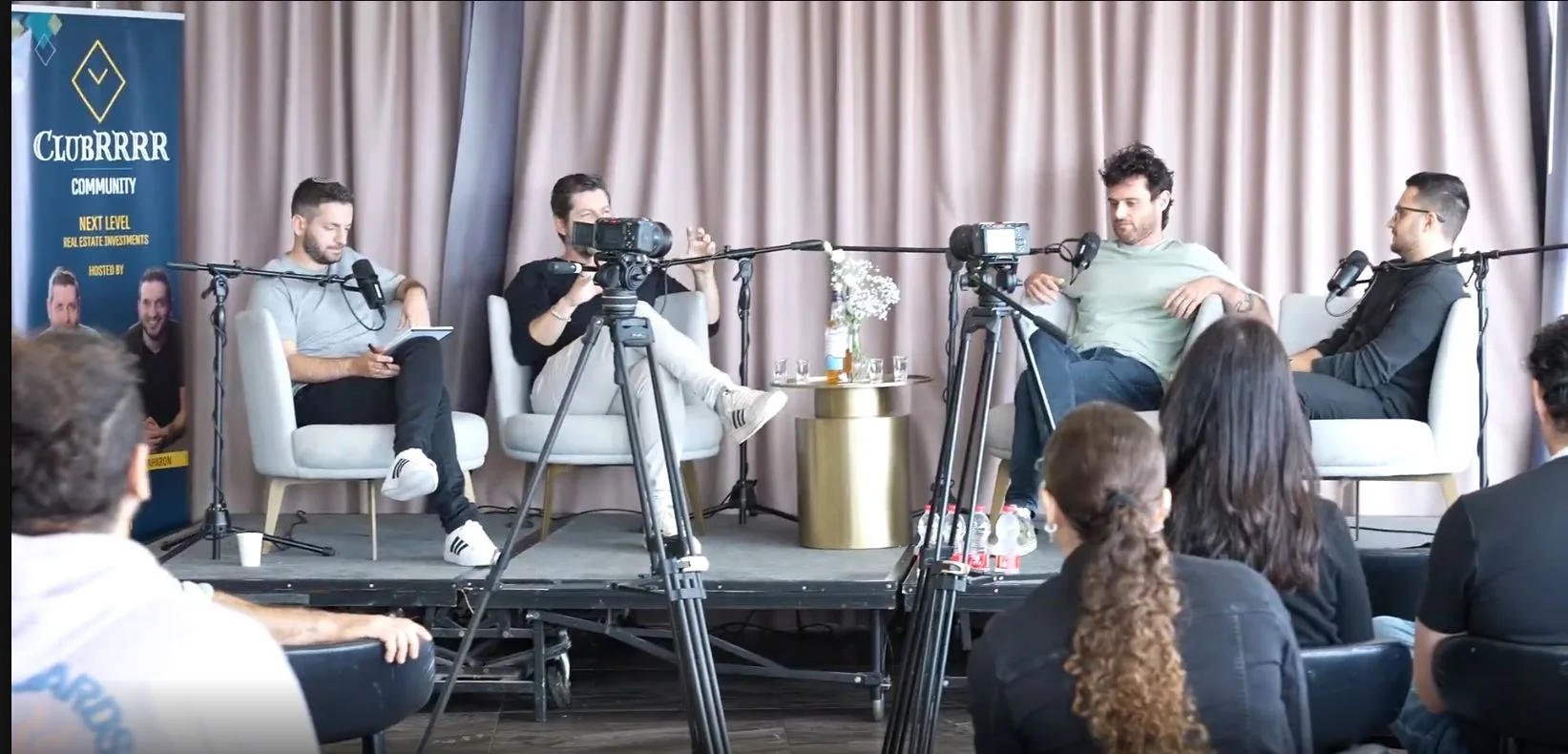 A panel on stage at ClubRRRR Accelerator 2026, recorded live in front of an audience
